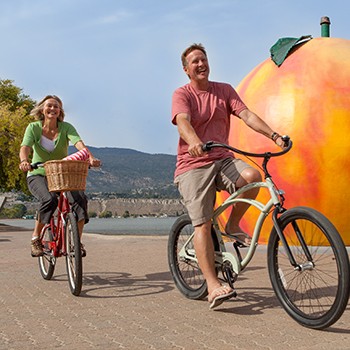 Couple Biking by the Penticton Peach